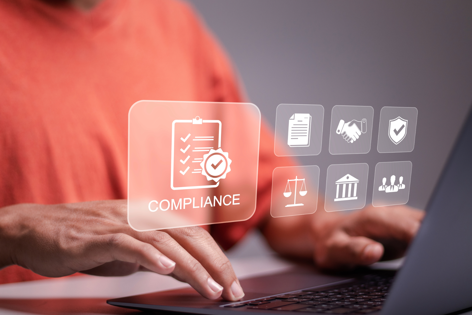 A person in an orange shirt types on a laptop, with floating digital icons related to compliance, including a checklist, handshake, document, scales, courthouse, shield, and group of people.