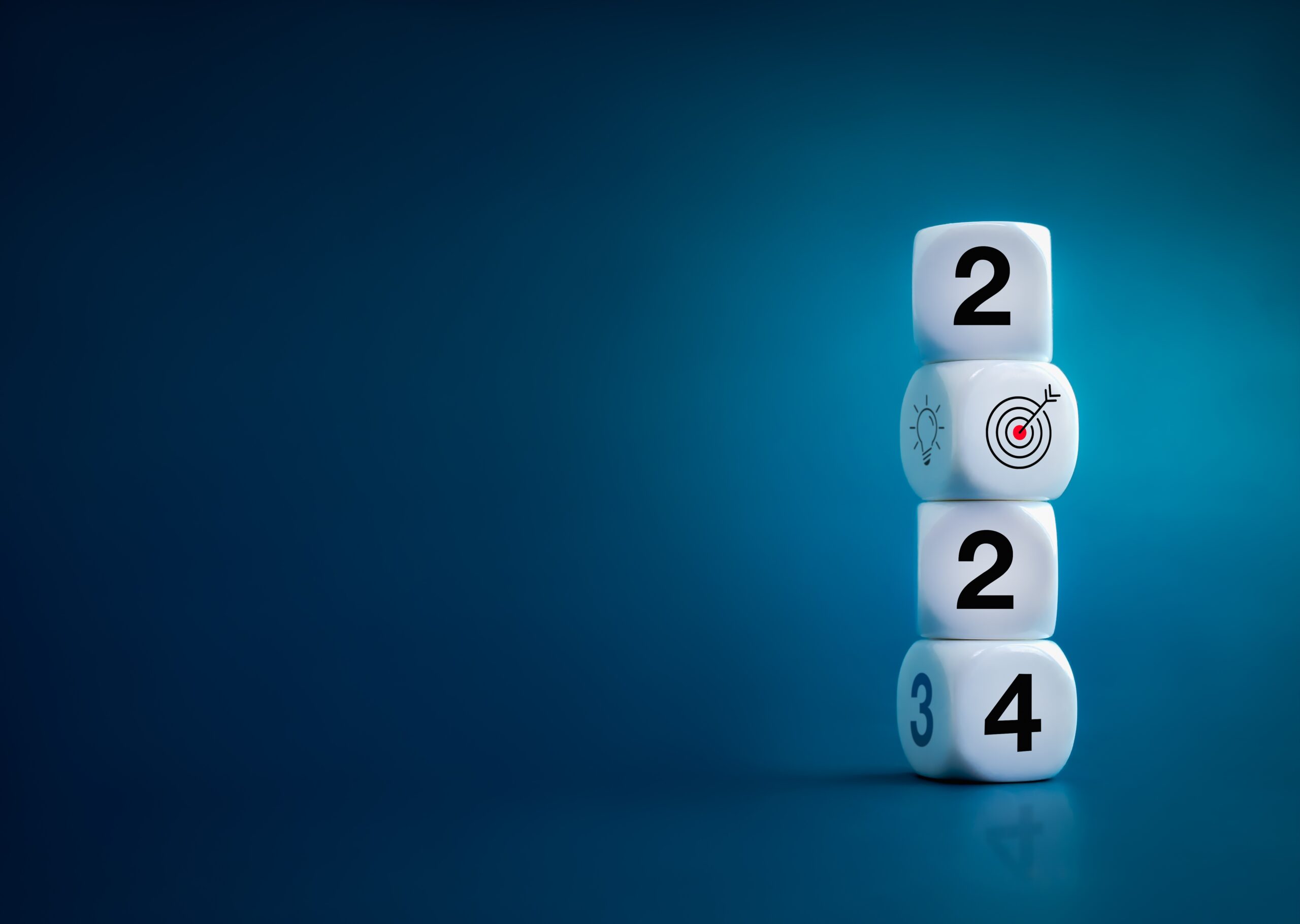 Four white dice are stacked vertically on a blue background. The dice display the numbers 2, 0 (with a target icon), 2, and 4 from top to bottom, symbolizing Network Resilience in the year 2024.